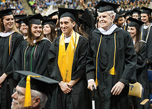 Ninety-year-old John Downs (standing in front row, far right) celebrates his Bachelor of Arts degree, which he received after the whims of fate postponed the moment for more than 60 years. He attended Pitt’s commencement with his large and loving family in the audience. Afterwards, he quipped:  “It’s nice to be out of college!”