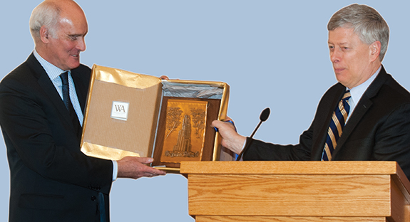 Ambassador Vale de Almeida accepts a gift of a craftsman’s depiction of the Cathedral of Learning from Pitt Chancellor Mark A. Nordenberg.  