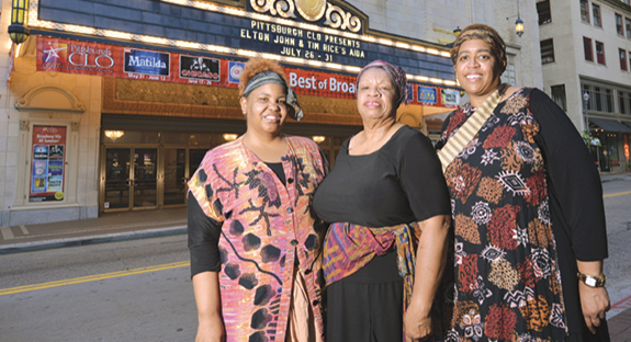 Two University staffers and an alumnus performed in the Pittsburgh Civic Light Opera’s Aida at the Benedum Center, Downtown, July 26-31. Standing in front of the show’s marquee are, from left, Tiffany Robinson, a teacher with Pitt’s Child Development Center; Gwen Watkins (CGS ‘15), the former community activities coordinator for Pitt’s Office of Community and Governmental Relations; and Michelle Denson-Laster, an administrative specialist in the Office of University Communications. The women are members of the Rodman Street Missionary Baptist Church, East Liberty. The CLO invited the church’s choir members to perform nightly in one of the musical’s scenes. (Photo by Nate Guidry)