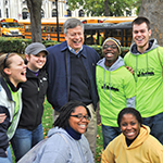 Chancellor Nordenberg jokes with a group of students during Pitt Make a Difference Day in 2011.