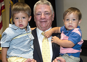 Stephen R. Tritch holds his grandsons, from left, Jack and Will Duncan
