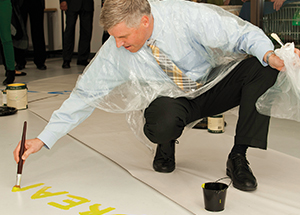Chancellor Patrick Gallagher gets creative during the March 14 Grand Opening of Pitt’s Center for Creativity: The Workshop. (Photo by Emily O'Donnell)