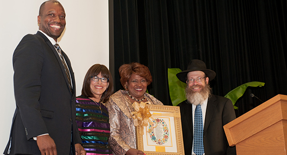 Chabad House on Campus honored Kathy Humphrey, Pitt senior vice chancellor for engagement and chief of staff, with its University Partners Award during a Sept. 1 gala at the O’Hara Student Center. Chabad House, established in 1988 by directors Rabbi Shmuel Weinstein and Sara Weinstein, is a Jewish organization that serves Pittsburgh-area college students and provides social, educational, and cultural programming. From left, Kenyon Bonner, Pitt interim vice provost and dean of students; Sara Weinstein; Kathy Humphrey; and Rabbi Shmuel Weinstein. Photo by Emily O'Donnell.
