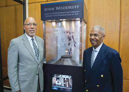 From left, Woodruff Jr. and Hill flank the  interactive display.